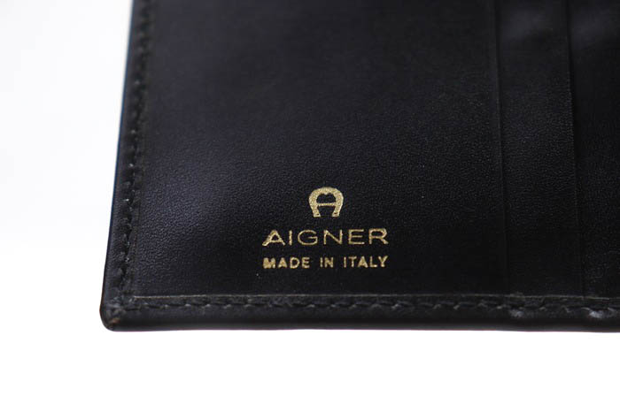 アイグナー 二つ折り財布 レザー イタリア製 小銭入れあり ブランド 小物 黒 メンズ ブラック AIGNER 【中古】｜AIGNER｜店舗買取｜財布 /小物＞財布｜USEDのアパレル通販サイト - SMASELL（スマセル）